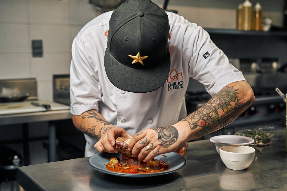 Professional chef carefully plating gourmet food for an event