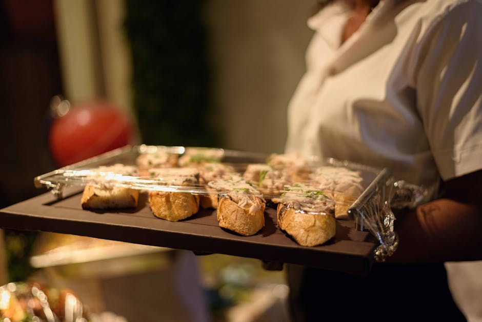 Waiter serving delicious appetizers on a tray at a wedding