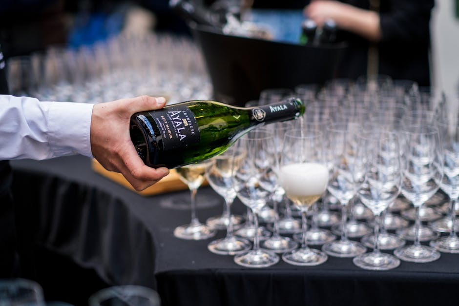 Bartender pouring champagne into elegant glasses for corporate guests
